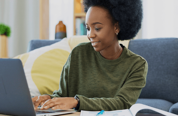 Lady smiling at her laptop